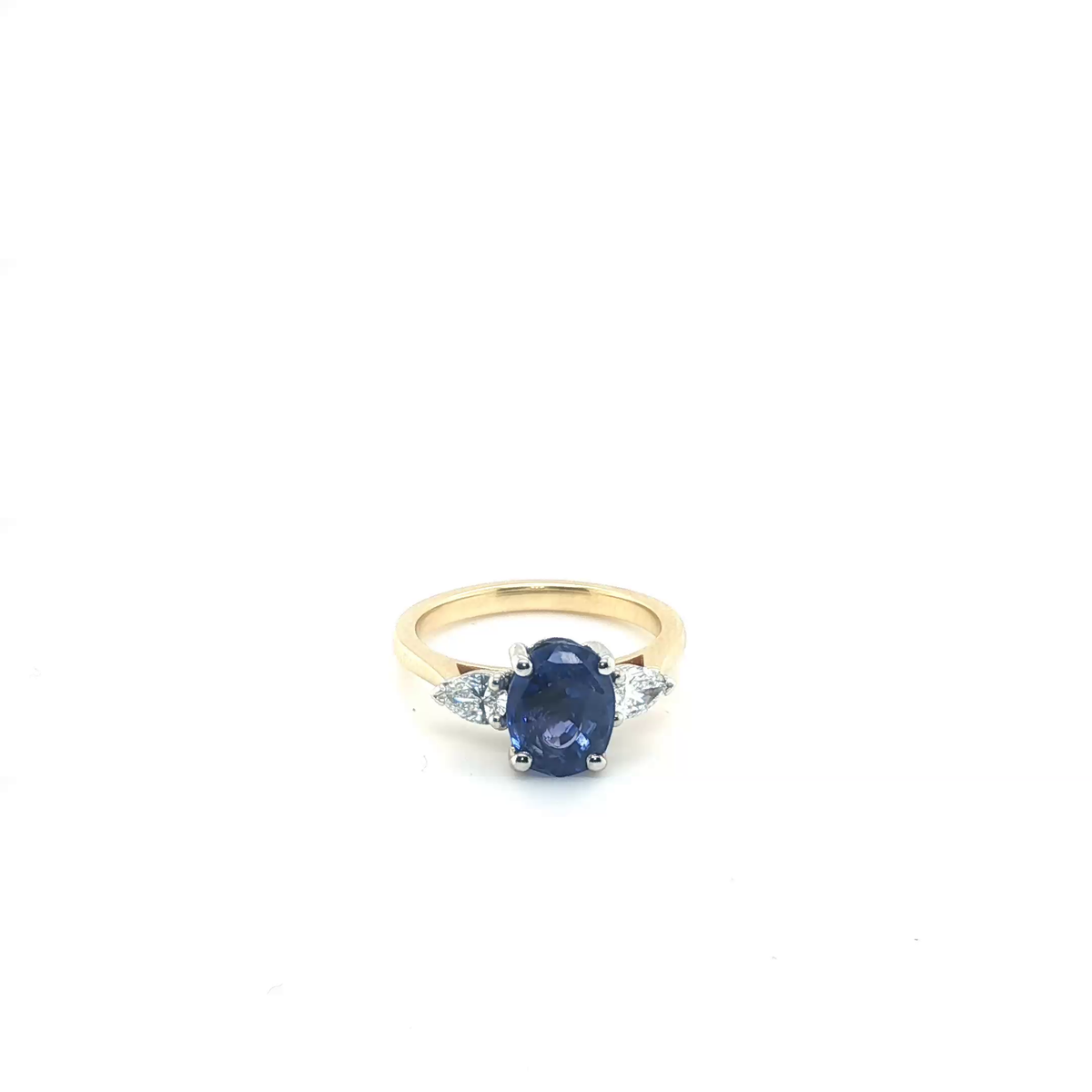 Oval Blue Sapphire and Pear Diamond Three-Stone Ring in Yellow Gold