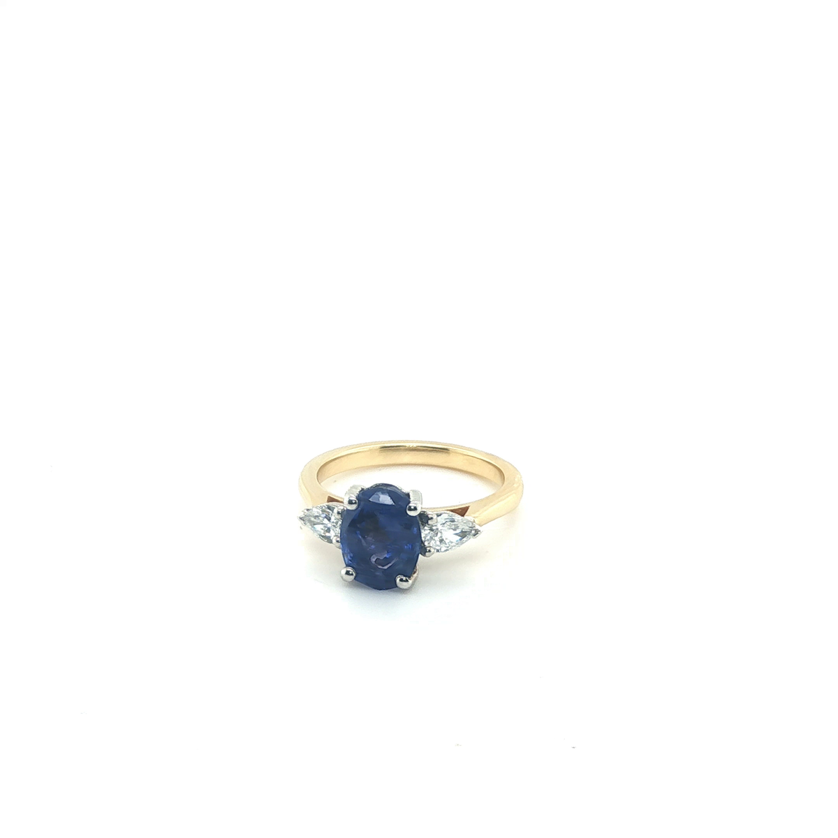 Oval Blue Sapphire and Pear Diamond Three-Stone Ring in Yellow Gold