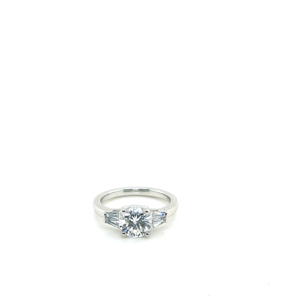 Round Brilliant and Tapered Baguette Diamond Three-Stone Engagement Ring in Platinum