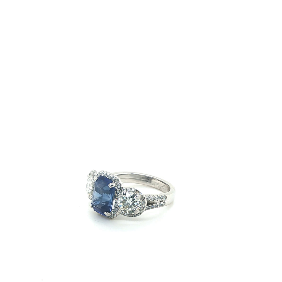 Emerald-Cut Blue Sapphire and Diamond Three-Stone Halo Ring in White Gold