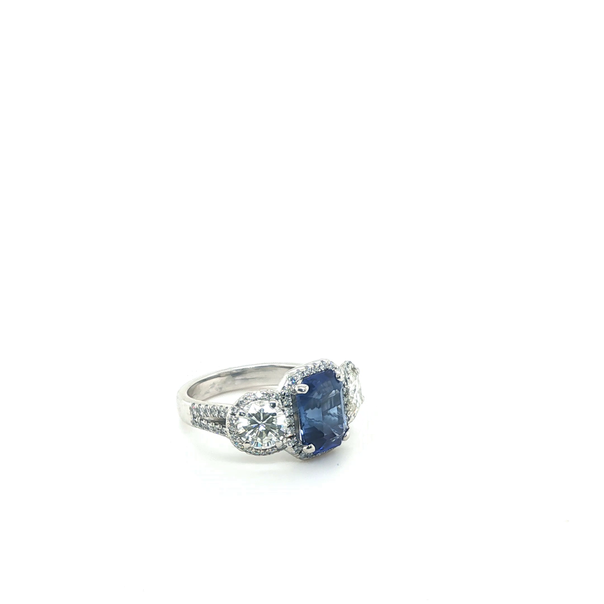 Emerald-Cut Blue Sapphire and Diamond Three-Stone Halo Ring in White Gold